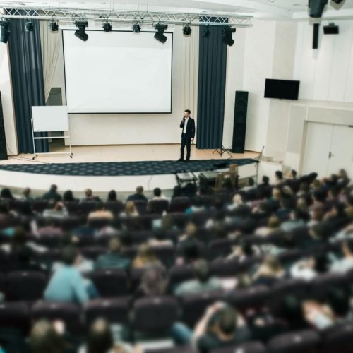 corporate event presentation with professional sound system and audience